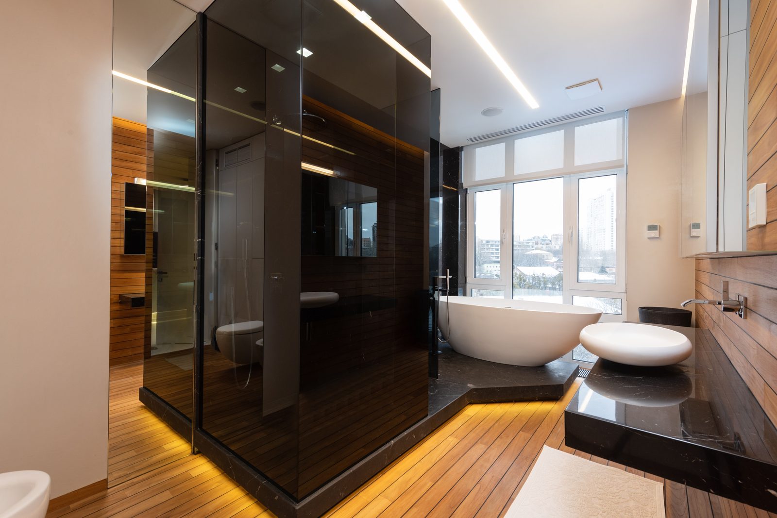 Custom smoked-glass shower enclosure installed by Makibaki in a Glencoe, IL bathroom