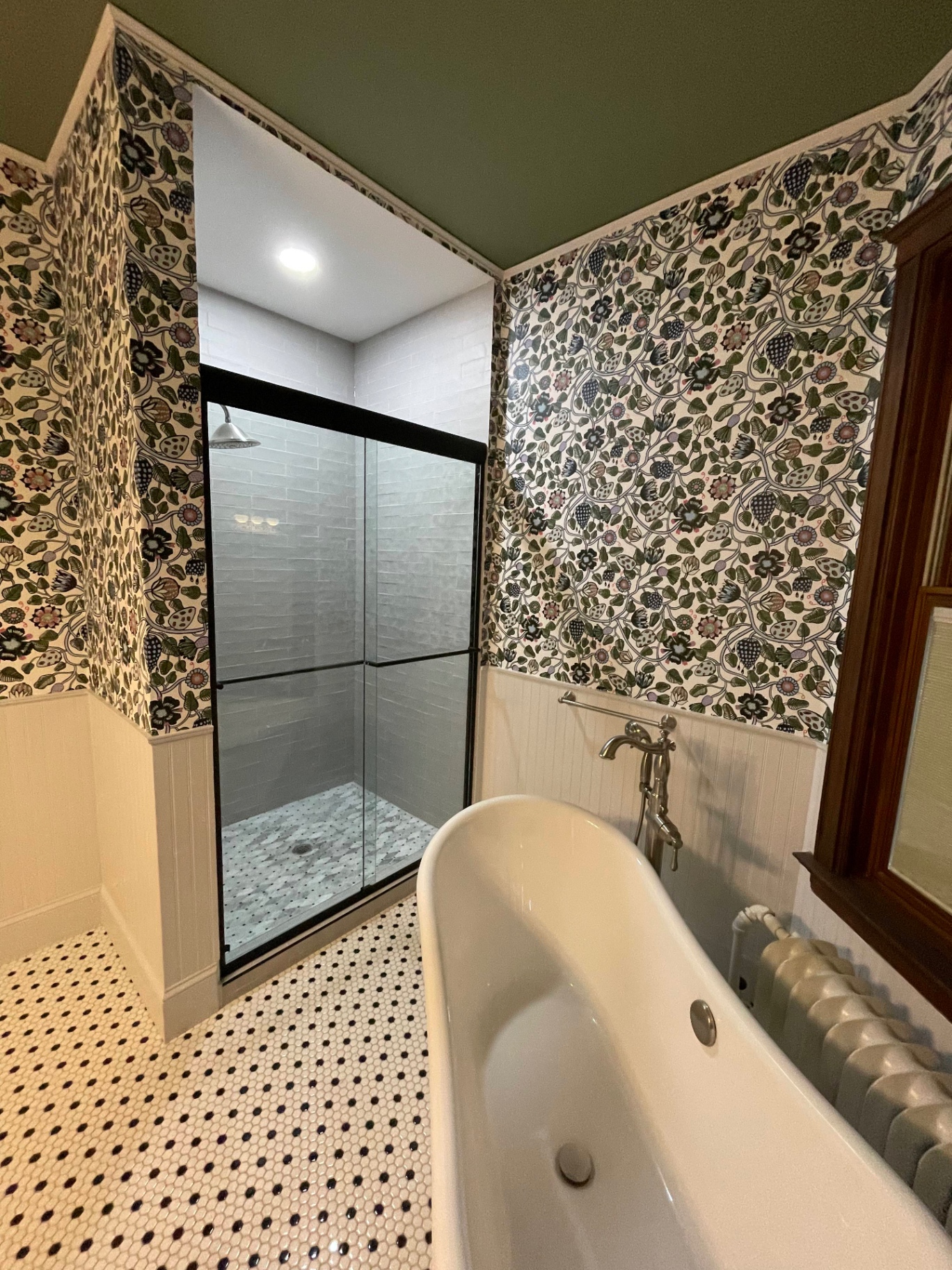 Frameless sliding shower door installed by Makibaki in an Evanston, IL bathroom