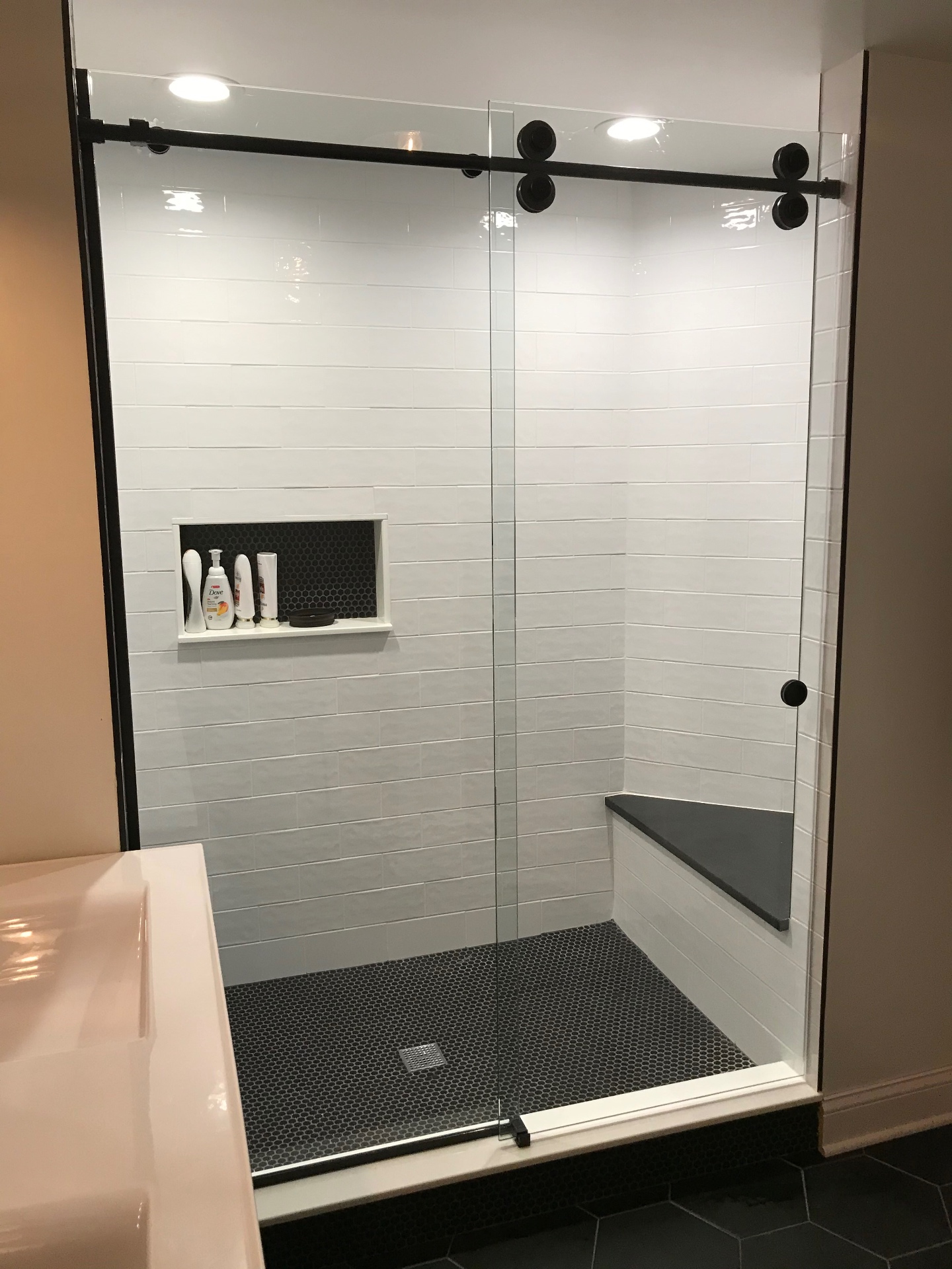 Frameless sliding shower door installed by Makibaki in a Rolling Meadows, IL bathroom