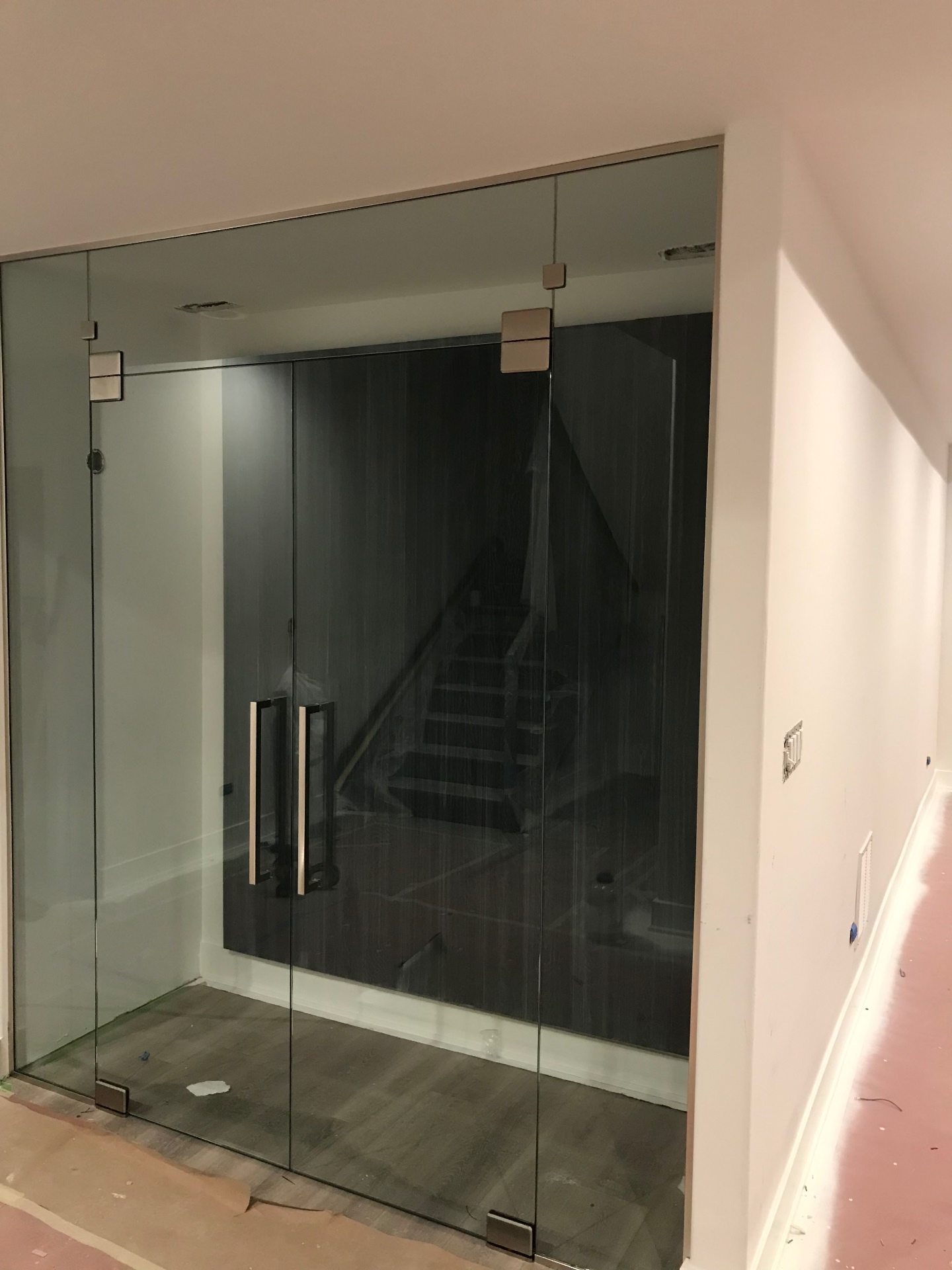 Frameless glass double doors and side panels for a wine room, fabricated and installed by Makibaki